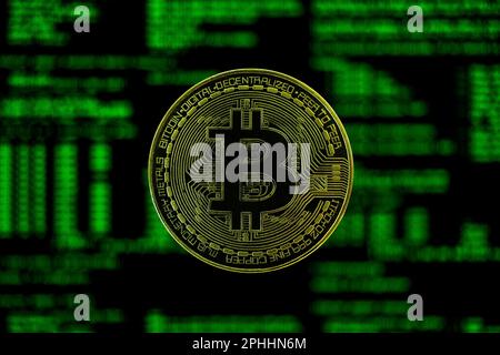 Bitcoin coin with computer code lines in the background; Black and green dark BTC coin wallpaper Stock Photo
