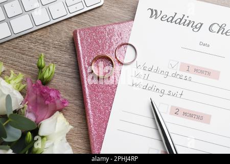 Flat lay composition with Wedding Checklist and planner on wooden table Stock Photo