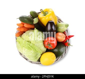 Wicker basket with fresh ripe vegetables and fruit on white background, top view Stock Photo
