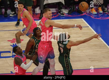 Washington, USA. 28th Apr, 2023. WASHINGTON, DC - MARCH 28: Washington Wizards center Kristaps Porzingis (6) deflects a shot by Boston Celtics guard Derrick White (9) during a NBA game between the Washington Wizards and the Boston Celtics, on March 28, 2023, at Capital One Arena, in Washington, DC. (Photo by Tony Quinn/SipaUSA) Credit: Sipa USA/Alamy Live News Stock Photo