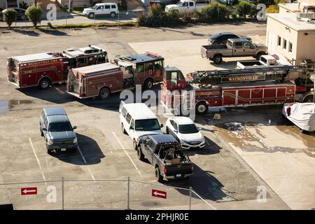 Watsonville, California, USA - January 1, 2023: A firefighter washes a fire engine at a Fire Station. Stock Photo