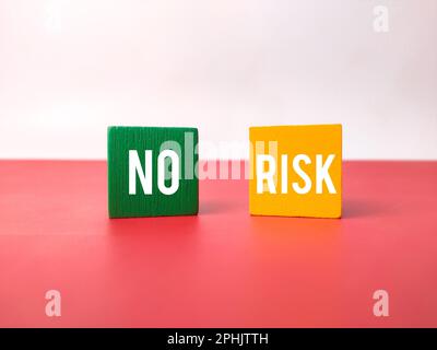 Colored cube with the word NO RISK on a white and red background. Business concept. Stock Photo