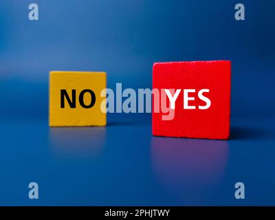 Colored cube with the word NO YES on a blue background. Business concept. Stock Photo