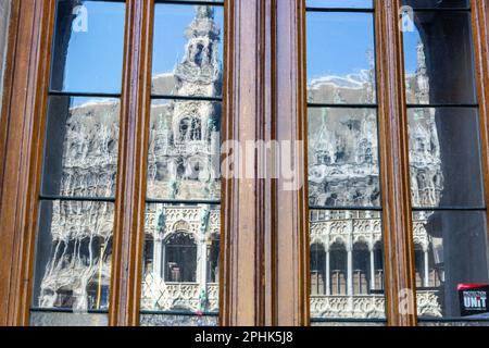 The Maison du Roi, on the Grand Place in Brussels, seen by reflection in the windows of the Hôtel de Ville. Stock Photo