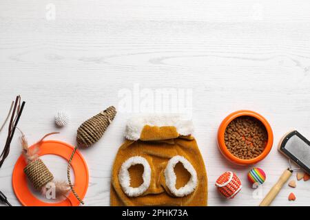 https://l450v.alamy.com/450v/2phk73a/flat-lay-composition-with-cat-clothes-food-and-accessories-on-white-wooden-table-space-for-text-2phk73a.jpg