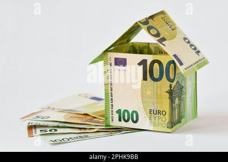 House made of euro banknotes on white background - Concept of building bonus, real estate investment, mortgage and home insurance Stock Photo