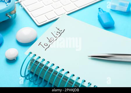Notepad with inscription To Do List and pen on light blue table, closeup Stock Photo