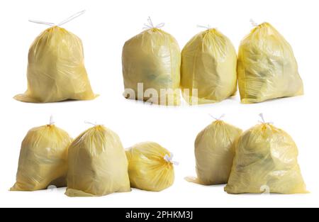 Set with yellow trash bags full of garbage on white background Stock Photo