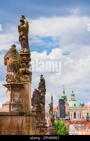 Charles Bridge beautiful 18th century baroque statues with Mala Strana Bridge Tower and St Nicholas Church Stock Photo