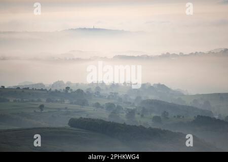 A misty spring morning with fog in the valleys from a hot air ballon flight near Tissington, in the White Peak area of the English Peak District Stock Photo
