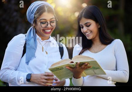 Books, reading or happy students in park on campus for learning, education or future goals together. Women smile, Muslim or friends studying with Stock Photo
