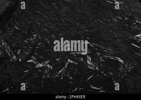 Crumpled Garbage Bag Texture Background. Wrinkled Trash Package Pattern, Used Plastic Bin Bags Mockup, Black Polyethylene Waste Container with Copy Sp Stock Photo