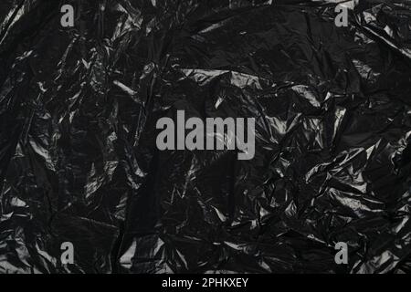 Crumpled Garbage Bag Texture Background. Wrinkled Trash Package Pattern, Used Plastic Bin Bags Mockup, Black Polyethylene Waste Container with Copy Sp Stock Photo
