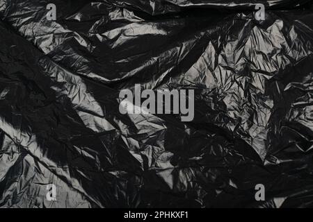 Crumpled Garbage Bag Texture Background. Wrinkled Trash Package Pattern, Used Plastic Bin Bags Mockup, Black Polyethylene Waste Container with Copy Sp Stock Photo