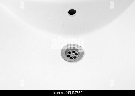 White ceramic hand wash wet sink in the bathroom top view, close-up Stock Photo