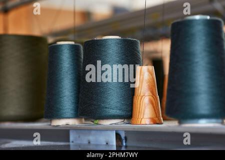 Three bobbins with industrial threads on cones Stock Photo