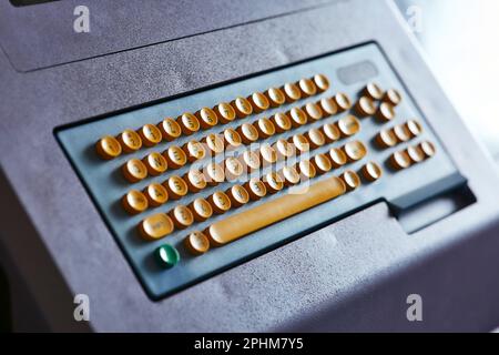 Built-in color keyboard with yellow mechanical buttons for the computer of a large industrial knitting machine Stock Photo