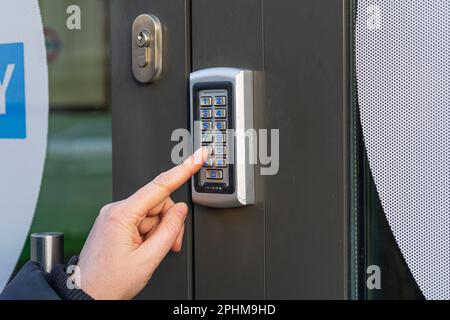 Secure Home System, Hand Pressing on Intercom Keypad, Using Door Phone, Doorphone, Entryphone, Videophone Call, Digital Electronic Doorbell Stock Photo