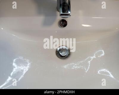 The plug hole of my bathroom hand basin. Yes, really. Don't you think it's pretty? OK, the reflections from a new illuminated shaving mirror probably Stock Photo