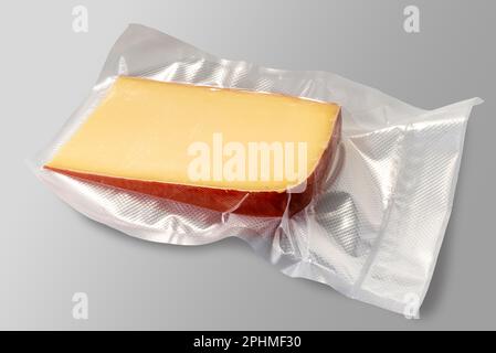 Fontal  cheese slice in vacuum pack for sous vide cooking isolated on gray background with clipping path included.clipping path included. Stock Photo