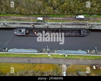 29 March 2023, Bavaria, Wörth An Der Donau: A wrecked ship lies in the Geisling lock. After the ship's accident, the lock chamber is to be filled slowly in order to get the wrecked ship out of the lock. (Shot with a drone) Photo: Felix Hörhager/dpa Stock Photo