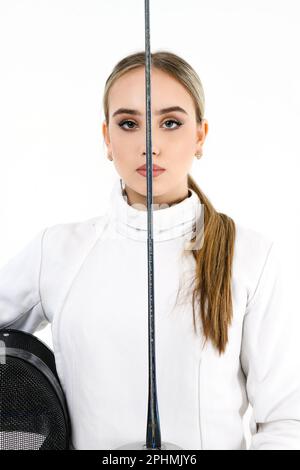 Portrait of a girl in a fencing costume with a mask and a sword Stock Photo