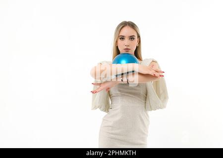 Girl gymnast dressed in an evening dress with a ball on a white background Stock Photo