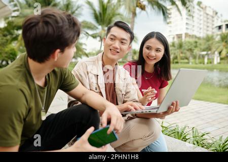 Group of students meeting outdoors to discuss project Stock Photo