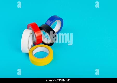 Colorful Electrical Tape, Plastic Duct Tape Rolls, Colored Adhesive Tapes on Blue Background Stock Photo
