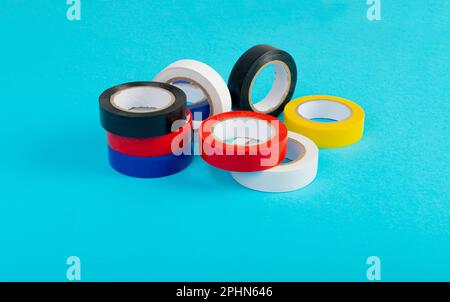 Colorful Electrical Tape, Plastic Duct Tape Rolls, Colored Adhesive Tapes on Blue Background Stock Photo