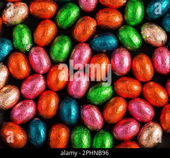 Colorful Easter eggs background. Chocolate Easter eggs texture. Top view Stock Photo