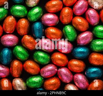 Colorful Easter eggs background. Chocolate Easter eggs texture. Top view Stock Photo