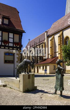 Billy Goat and Peasant Woman (Geißbock und Bäuerin), sculpture group in front of the town hall, Dettingen an der Erms, Baden-Württemberg, Deutschland. Stock Photo