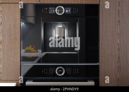 Built-in fully automatic coffee machine in kitchen furniture Stock Photo