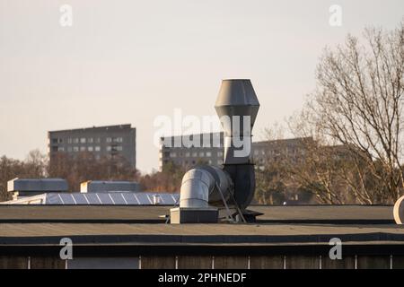 Ventilation duct and fan on the roof of a building Stock Photo