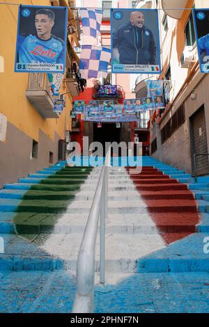 Naples, Italy. 29th Mar, 2023. A staircase in the center of the Spanish Quarter wearing the colors of the SSC Napoli soccer team and carrying the effigy of the 'scudetto,' the symbol with the colors of the Italian flag that is affixed to the jersey of the team that wins the Italian Serie A soccer championship. Preparations are in full swing in the city to celebrate the final victory of SSC Napoli, which leads the Italian championship with 19 points. Credit: Independent Photo Agency/Alamy Live News Stock Photo