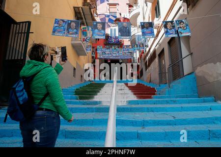 Naples, Italy. 29th Mar, 2023. Tourist take photos of the steps in the center of the Spanish Quarter wears the colors of the SSC Napoli soccer team and bears the effigy of the 'scudetto,' the symbol with the colors of the Italian flag that is affixed to the jersey of the team that wins the Italian Serie A soccer championship. Preparations are in full swing in the city to celebrate the final victory of SSC Napoli, which leads the Italian championship with 19 points. Credit: Independent Photo Agency/Alamy Live News Stock Photo