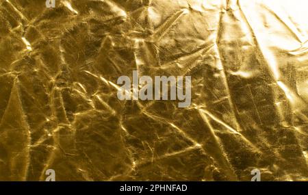 Crumpled Gold Fabric Texture Background, Wrinkled Bronze Pattern, Luxury Yellow Metallic Paper Mockup with Copy Space Stock Photo
