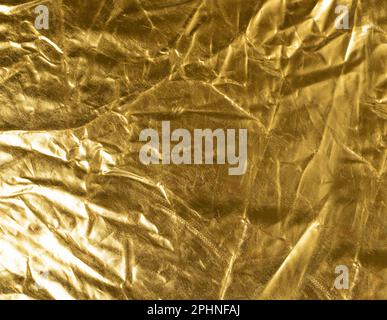 Crumpled Gold Fabric Texture Background, Wrinkled Bronze Pattern, Luxury Yellow Metallic Paper Mockup with Copy Space Stock Photo