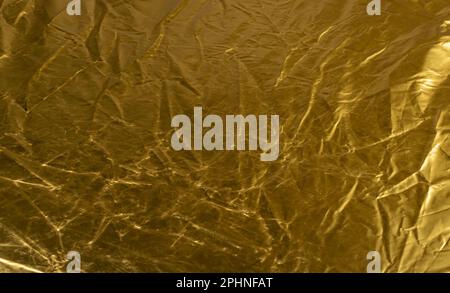 Crumpled Gold Fabric Texture Background, Wrinkled Bronze Pattern, Luxury Yellow Metallic Paper Mockup with Copy Space Stock Photo