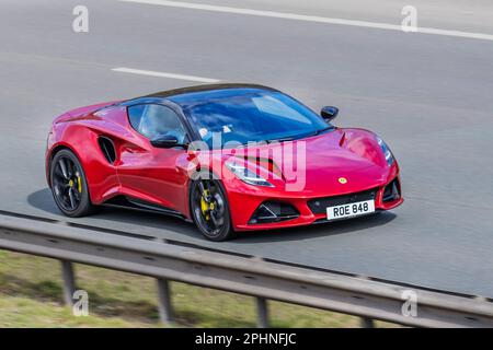 2023 Magma Red LOTUS EMIRA V6 First EDITION 3456 cc 6 Speed manual, all-electric Lotus Eletre is a striking and progressive Hyper SUV, with V-spoke forged alloy wheels; travelling on the m61 motorway, UK Stock Photo