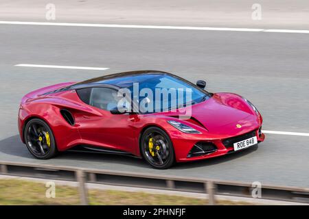 2023 Magma Red LOTUS EMIRA V6 First EDITION 3456 cc 6 Speed manual, all-electric Lotus Eletre is a striking and progressive Hyper SUV, with V-spoke forged alloy wheels; travelling on the m61 motorway, UK Stock Photo
