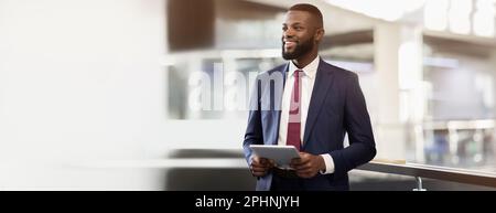 Smiling handsome confident african american millennial businessman ceo with beard use tablet, look at free space Stock Photo