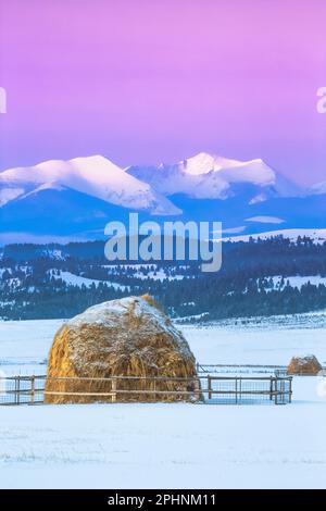 first light of winter sunrise on peaks of the flint creek range above haystacks near avon, montana Stock Photo