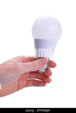 LED light bulb in hand isolated on white background. Energy saving lamp. Stock Photo