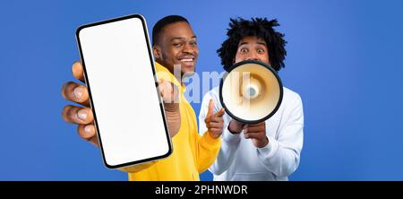 Great Promo. Two Black Guys Showing Blank Smartphone And Using Megaphone Stock Photo