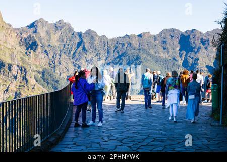 tourists at the Eira Do Serrado viewpoint, overlooking the Curral Das Reiras,  Nuns Valley, Funchal, Madeira, Portugal Stock Photo