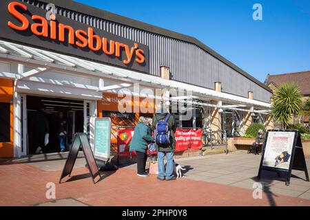 Customers outside Sainsburys supermarket on a sunny spring day in March 2023 Stock Photo