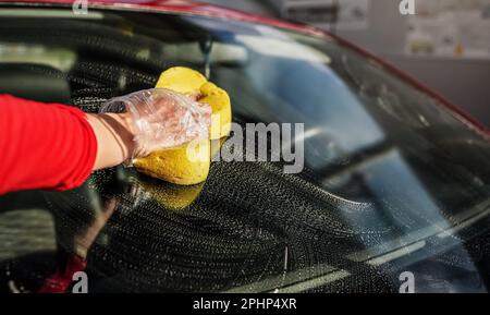 Hand Cleaning Car Windshield With Sponge Stock Photo - Alamy