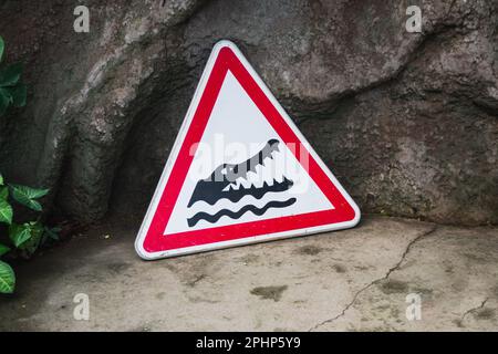 Red road sign beware of crocodiles. Attention crocodiles Stock Photo